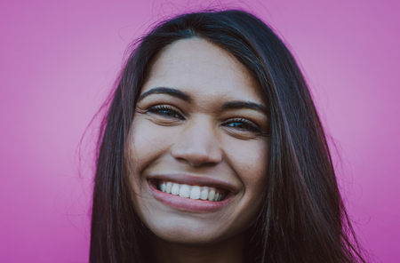 Happy teenager portrait on colored backgroundsの写真素材