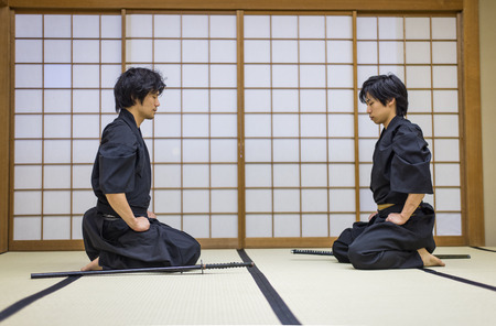 Japanese martial arts athlete training kendo in a dojo - Samaurai practicing in a gymの写真素材