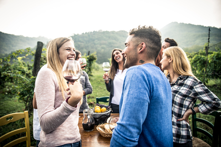 Group of friends at restaurant outdoors - People having dinner in a home gardenの写真素材