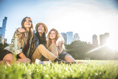 Multi-ethnic group of friends in Central Park, Manhattan - Young cheerful people bonding outdoorsの写真素材