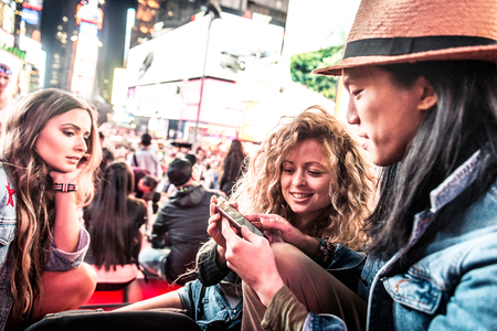 Group of friends taking a selfie in Times Square, Manhattanの写真素材