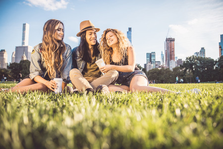 Multi-ethnic group of friends in Central Park, Manhattan - Young cheerful people bonding outdoorsの写真素材