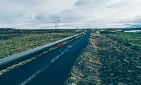 Couple of skateboarders on the icelandic roads