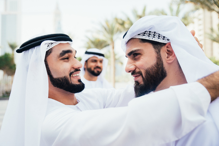 Group of businessmen talking on the street in Dubaiの写真素材