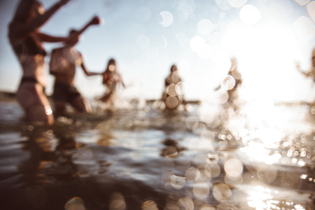 Friends having fun at the sea, blurry conceptの写真素材