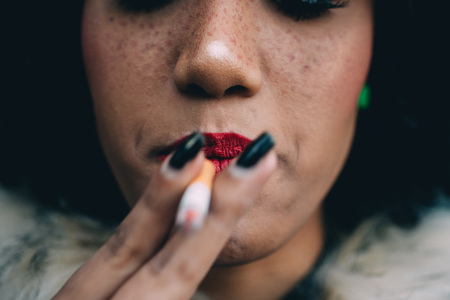 Woman smoking, close up on smoke and mouth