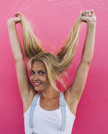 Beautiful girl lifestyle moments on colored backgroundsの写真素材
