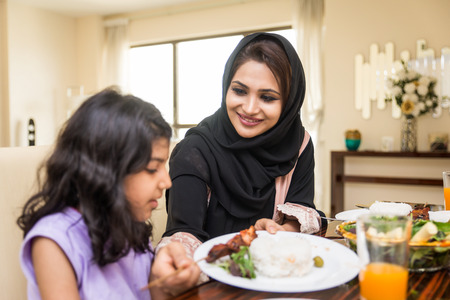 Happy arabian family having fun at homeの写真素材