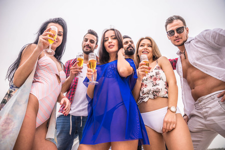 Group of friends making party on a yacht in Dubai - Happy people having a fancy party on a luxury boatの写真素材