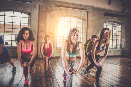Group of sportive people training in a gym - Multi-ethnic group of athletes doing fitnessの写真素材