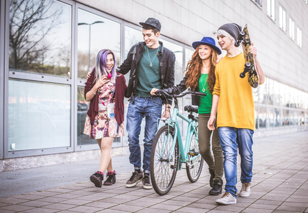 Multi-ethnic group of teens bonding outdoors