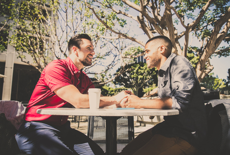 Homosexual couple at a romantic date outdoors - Gay couple in love flirting and having funの写真素材