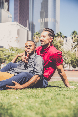 Homosexual couple at a romantic date outdoors - Gay couple in love flirting and having funの写真素材