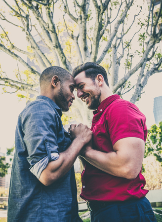 Homosexual couple at a romantic date outdoors - Gay couple in love flirting and having funの写真素材