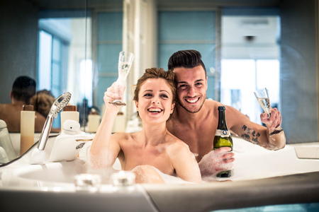 Young happy  couple enjoying an hot bath in the hot tub