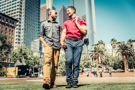 Homosexual couple at a romantic date outdoors - Gay couple in love flirting and having funの写真素材