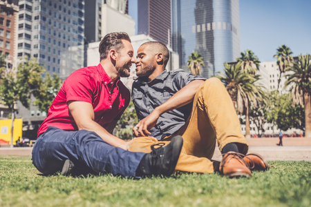 Homosexual couple at a romantic date outdoors - Gay couple in love flirting and having funの写真素材