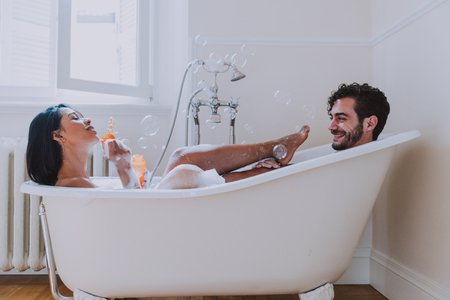 Couple in love spending time together in the house. Romantic moments in the bathroomの写真素材