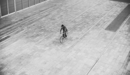 Handsome young business man with his modern bicycle.の写真素材