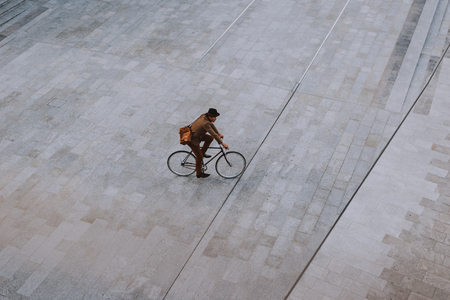 Handsome young business man with his modern bicycle.の写真素材