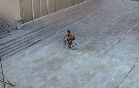 Handsome young business man with his modern bicycle.の写真素材