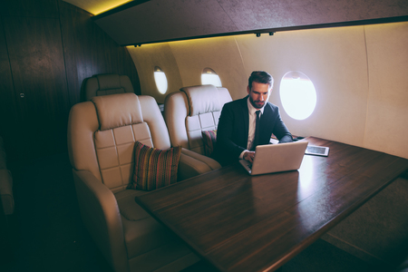 Businessman flying on his private jetの写真素材
