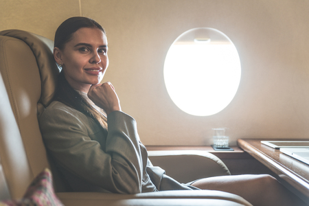 Business woman traveling and working on the private jetの写真素材