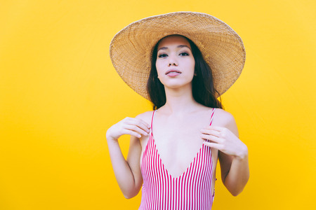 Beautiful asian young woman with bikini. Portraits on colored backgroundsの写真素材