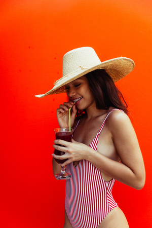 Beautiful asian young woman with bikini. Portraits on colored backgroundsの写真素材