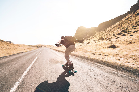 Skater traveling iceland on his longboard