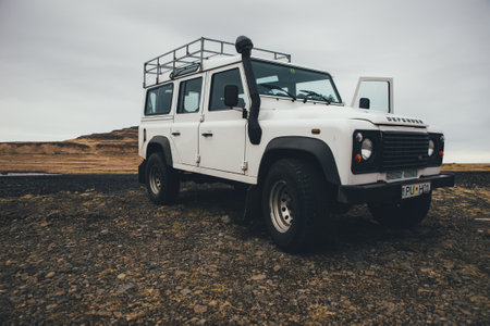 ICELAND, KIRKJUFELL, 16TH APRIL 2018. The land Rover defender parked in front the kirkjufell. The Defender  is a four-wheel drive off-road vehicle developed in the 1980sのeditorial素材