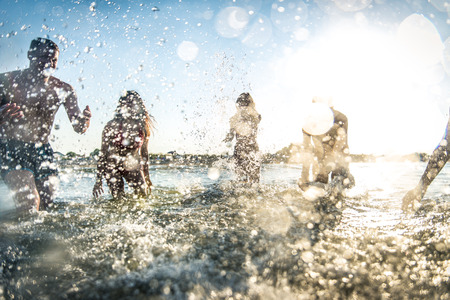 Group of friends having fun at the sea - Happy young people on a summer vacation at the beach