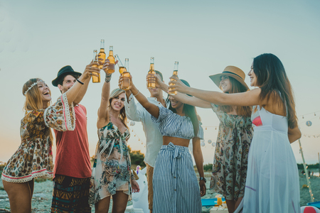 Happy group of friends celebrating and having fun on the beach - Young people on summer holidayの写真素材