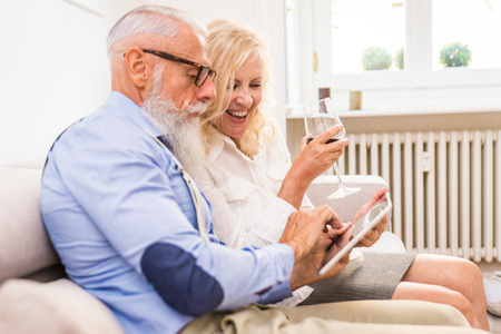 Senior couple in the 60's having fun at home - Cheerful married couple portrait, concepts about seniority and relationshipの写真素材