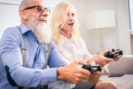 Senior couple in the 60's having fun at home - Cheerful married couple portrait, concepts about seniority and relationshipの写真素材