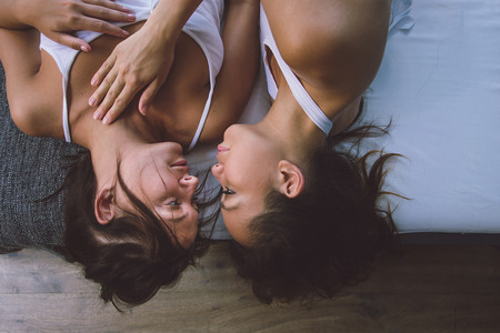 Lesbic couple at home, intimate moments of private life - Homosexual partners loving themselves