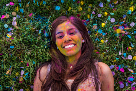 Group of happy friends playing with holi colors in a park - Young adults having fun at a holi...