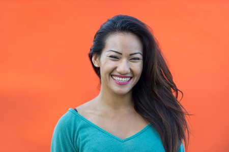 Young happy girl on colored backgroundの写真素材