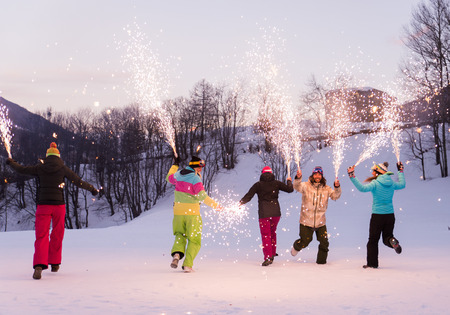 Happy group of people having fun on winter vacation - Friends with snow suit partying outdoorsの写真素材