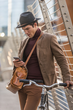 Young handsome man with casual clothes driving bycicle - Young student portrait, concepts about business, mobility and lifestyleの写真素材