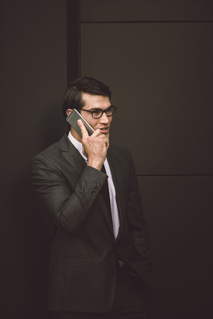 Young handsome man with business suit driving bycicle - Corporate businessman portrait, concepts about business, mobility and lifestyleの写真素材