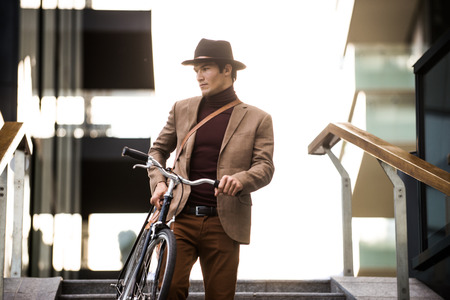 Young handsome man with casual clothes driving bycicle - Young student portrait, concepts about...