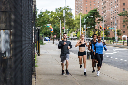 Group of urban runners running on the street in New york city, conceptual series about sport and fitnessの写真素材