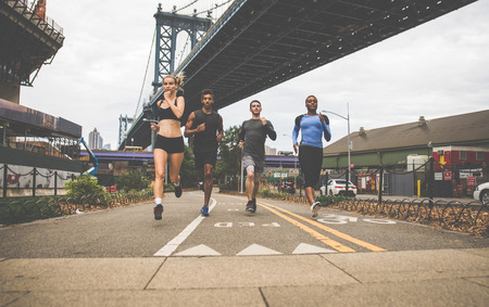 Group of urban runners running on the street in New york city, conceptual series about sport and...