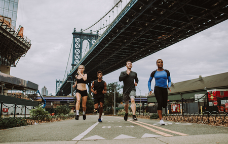 Group of urban runners running on the street in New york city, conceptual series about sport and fitnessの写真素材
