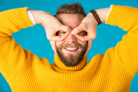 Young happy and playful man having fun -