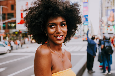 Young beautiful girl walking in Time square, manhattan. Lifestyle concepts about New yorkの写真素材