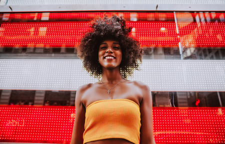 Young beautiful girl walking in Time square, manhattan. Lifestyle concepts about New yorkの写真素材
