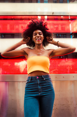 Young beautiful girl walking in Time square, manhattan. Lifestyle concepts about New york
