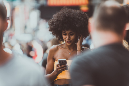 Young beautiful girl walking in Time square, manhattan. Lifestyle concepts about New yorkの写真素材